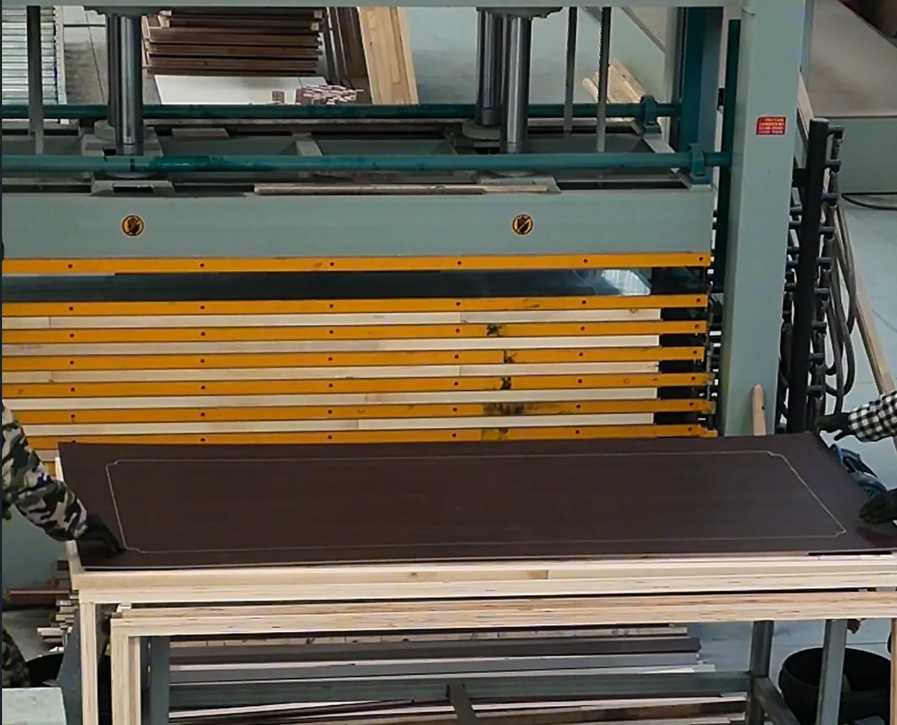 Flush door panel undergoing automated surface processing at the factory